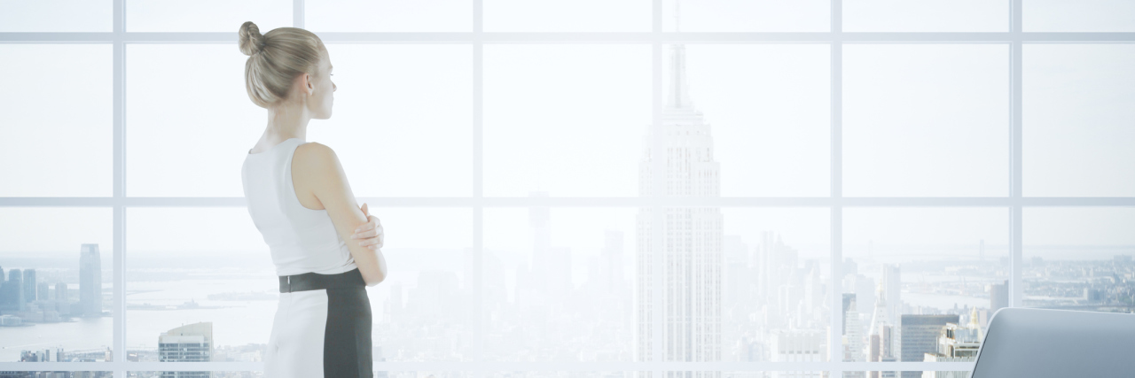 Not Looking Forward to Retirement With Rheumatoid Arthritis businesswoman looking out her office window