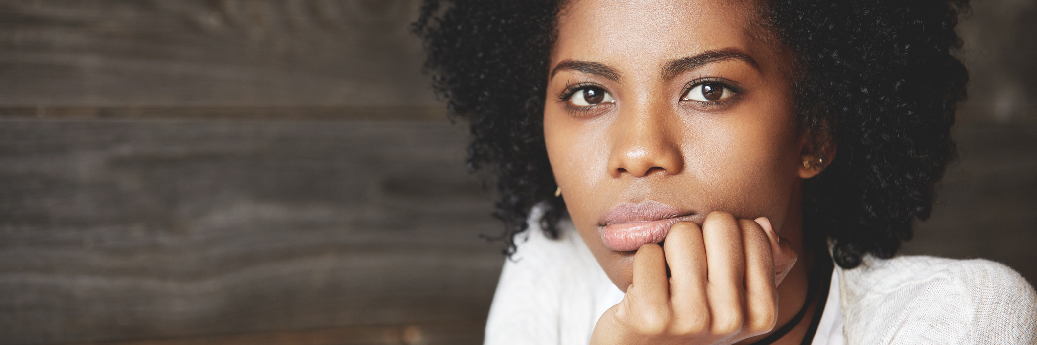 7 Ways I Take Care of My Mental Health While Living With RA A sad looking African American woman.