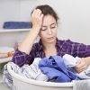 Frustrated young woman with basket full of clothes