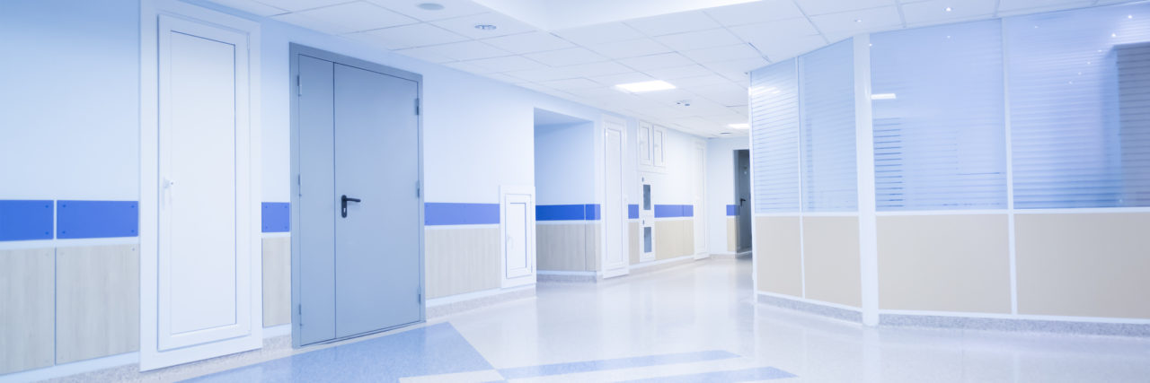 Corridor in hospital with carts illuminated by sunlight