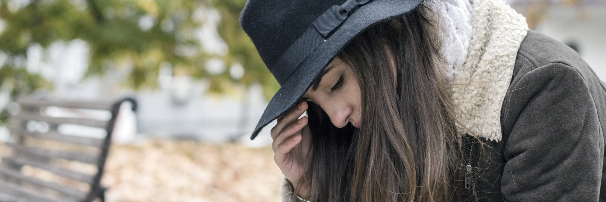 When a Person With Anxiety Seems Like They Don't Care young woman struggling with anxiety or depression sitting alone