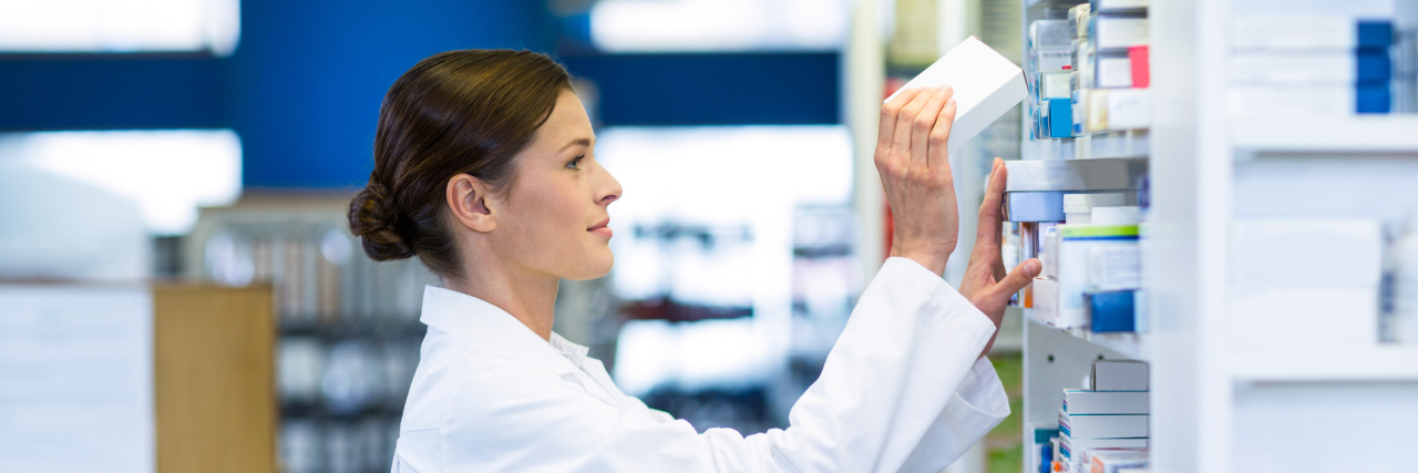 When a Pharmacist Was Rude About Prescription Opiates for Chronic Pain pharmacist putting medication on a shelf