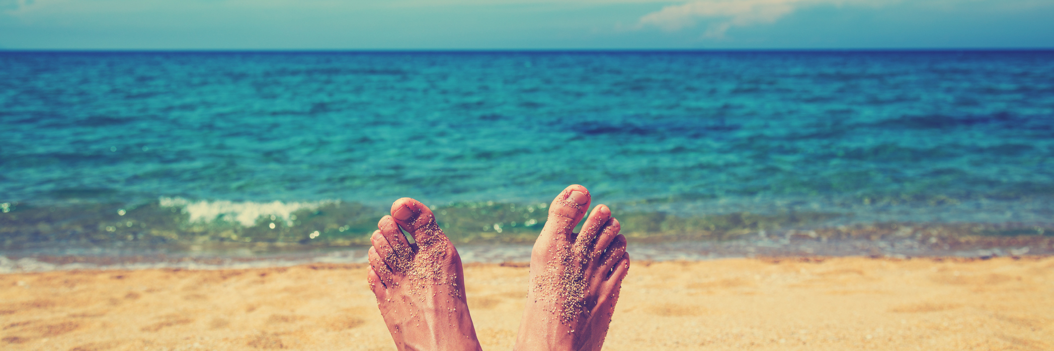 Interstitial Cystitis: Not Worrying About Health on Beach Vacation woman's feet relaxing on beach