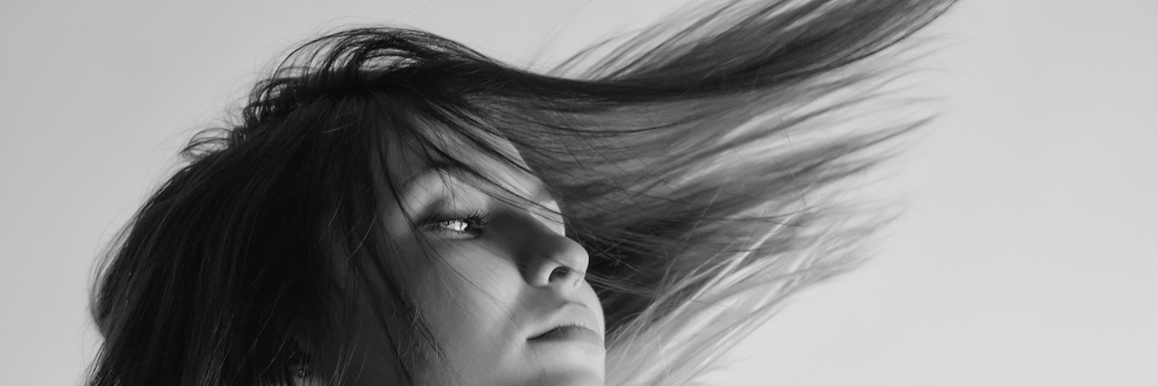 The Gray Area Between Mental Illness Diagnoses A woman with her hair blowing behind her