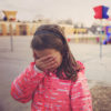 Sad girl in the school playground.