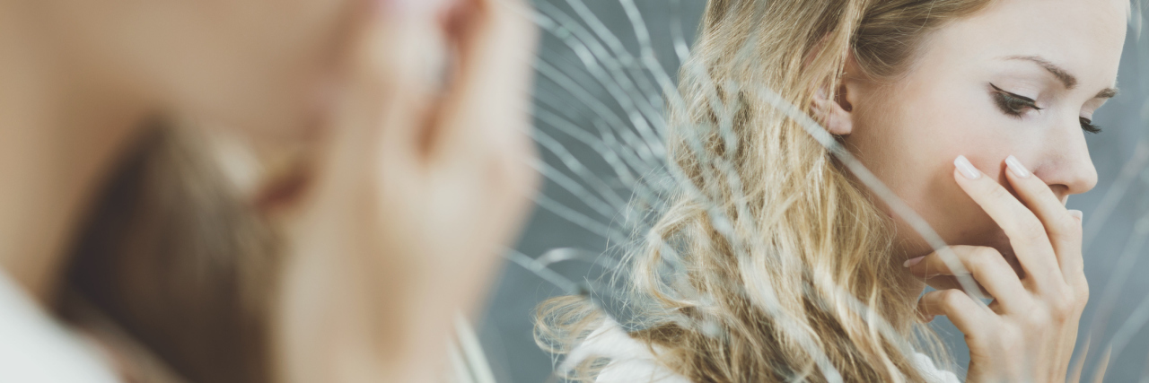 How Rewarding Myself for Something Small Affected My Self-Worth upset girl standing in front of broken mirror with focus on reflection