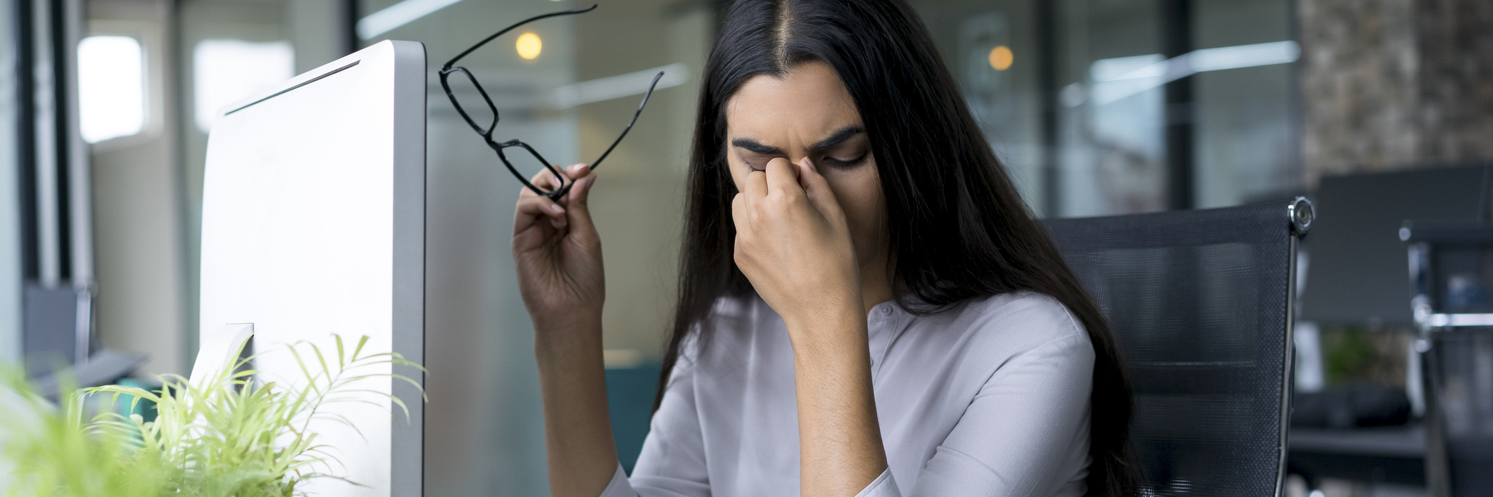 What People Should Know About Fatigue From Multiple Sclerosis tired woman rubbing her eyes while working