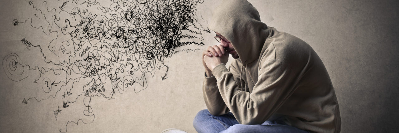 I Am OK but the Memory of Testicular Cancer Still Remains Young man is sitting on the ground alone