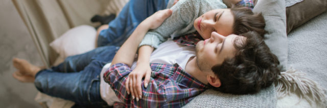 young couple embracing on bed comforting