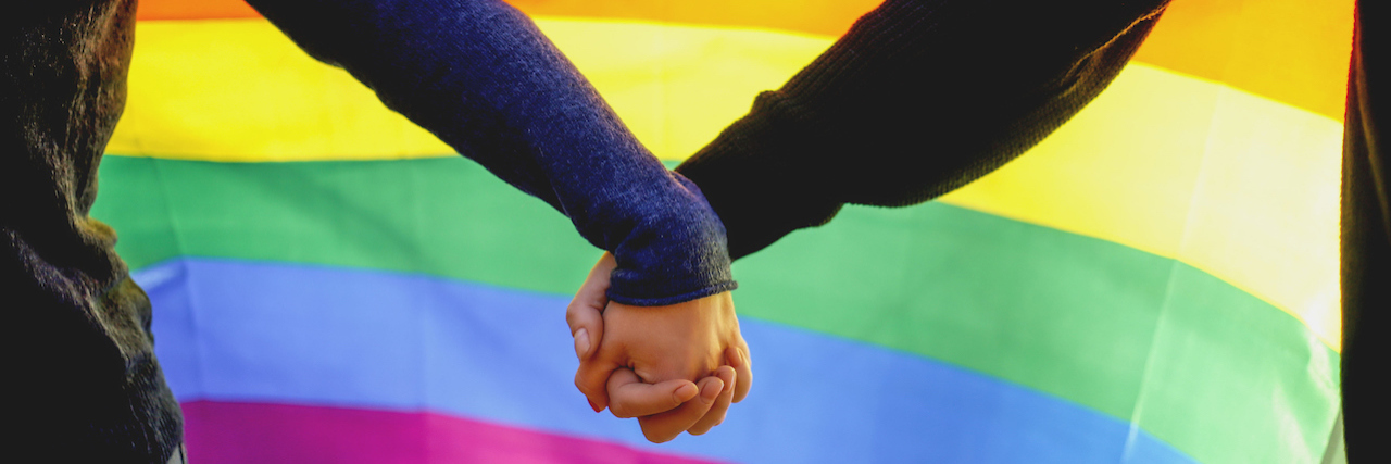 Mental Health Reminders: Trump's Transgender Military Ban Two lesbian girls holding hands and rainbow flag