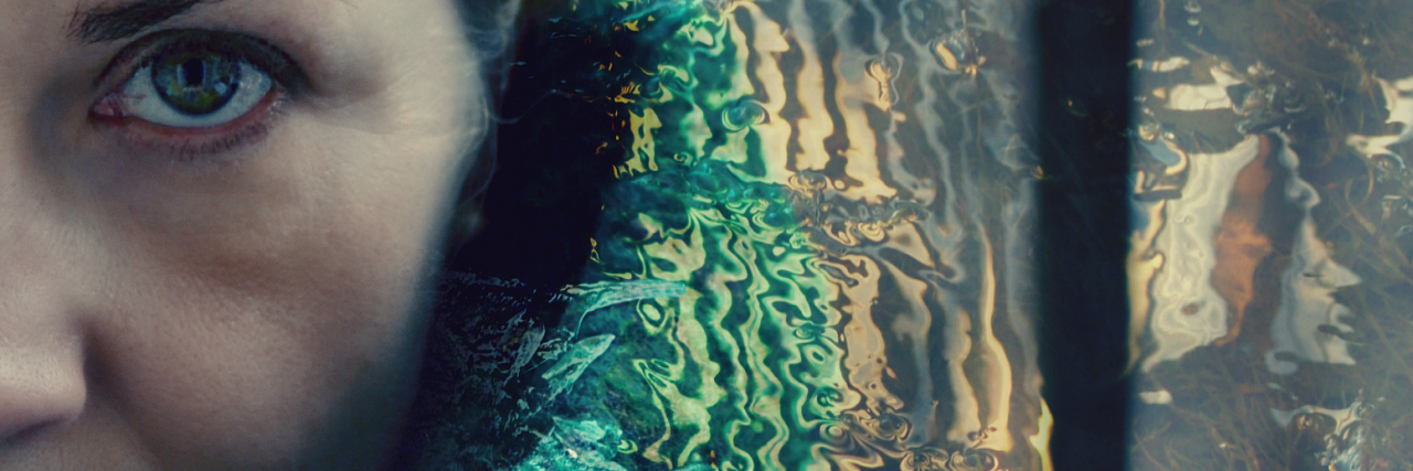 Double exposure portrait of a woman in green shawl combined with water ripples