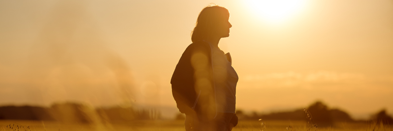 ME/CFS, Fibromyalgia: Learning Gratitude From Chronic Illness woman standing in a sunlit field