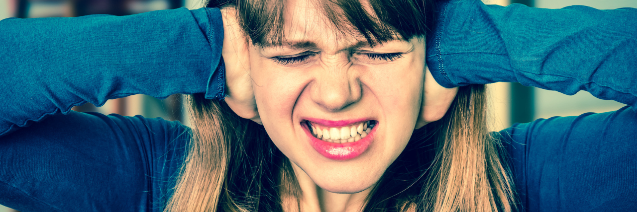How Noise Affects Me During a Depressive Episode young woman covering ears against noise