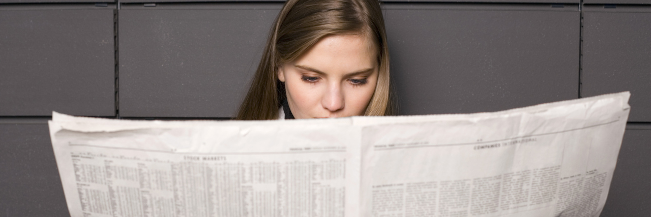 What to Remind Yourself When the News Is Bad for Your Mental Health A woman reading the newspaper
