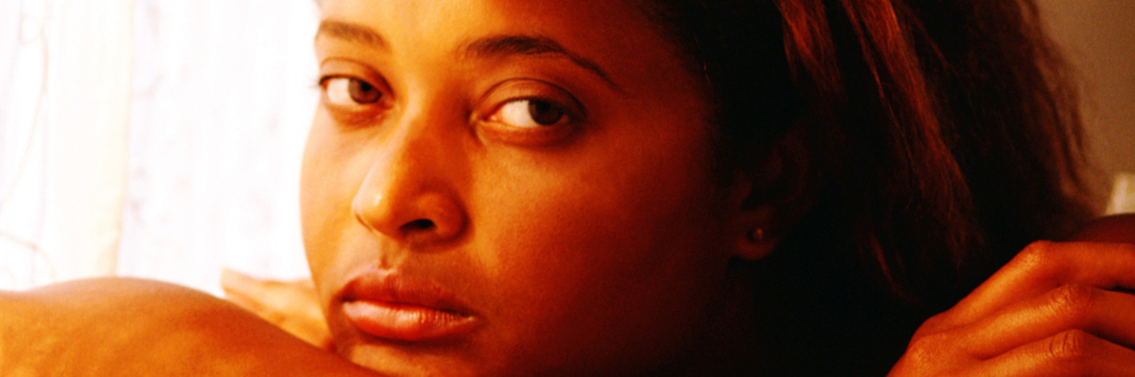 A Therapist Called Me a 'Strong Black Woman' Instead of Helping A young woman sitting on a couch