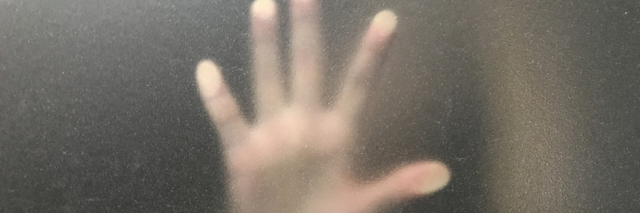 When I Wonder If I Can Fight My Chronic Pain for Forever A hand blurred behind a window.