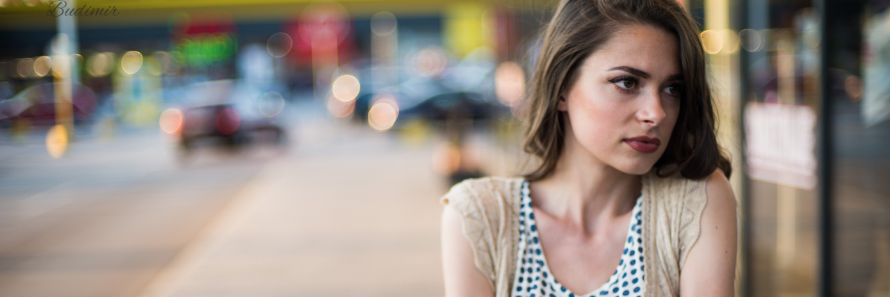 When Borderline Personality Disorder Makes You Feel Numb portrait of woman looking numb in street holding arms crossed