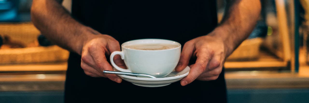 How One Caffeinated Coffee Had a Huge Impact on My Bipolar Disorder male barista handing over coffee