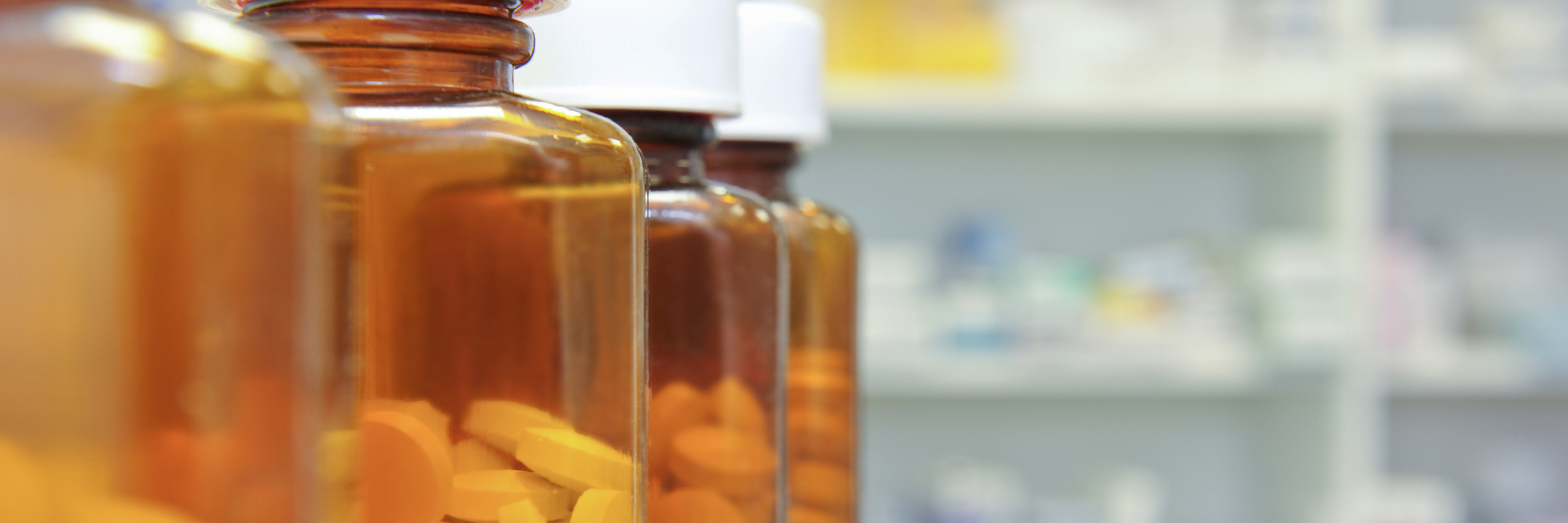 People With Chronic Pain Respond After Trump Calls Opioids 'No Good' row of bottles and pills on a chemists counter