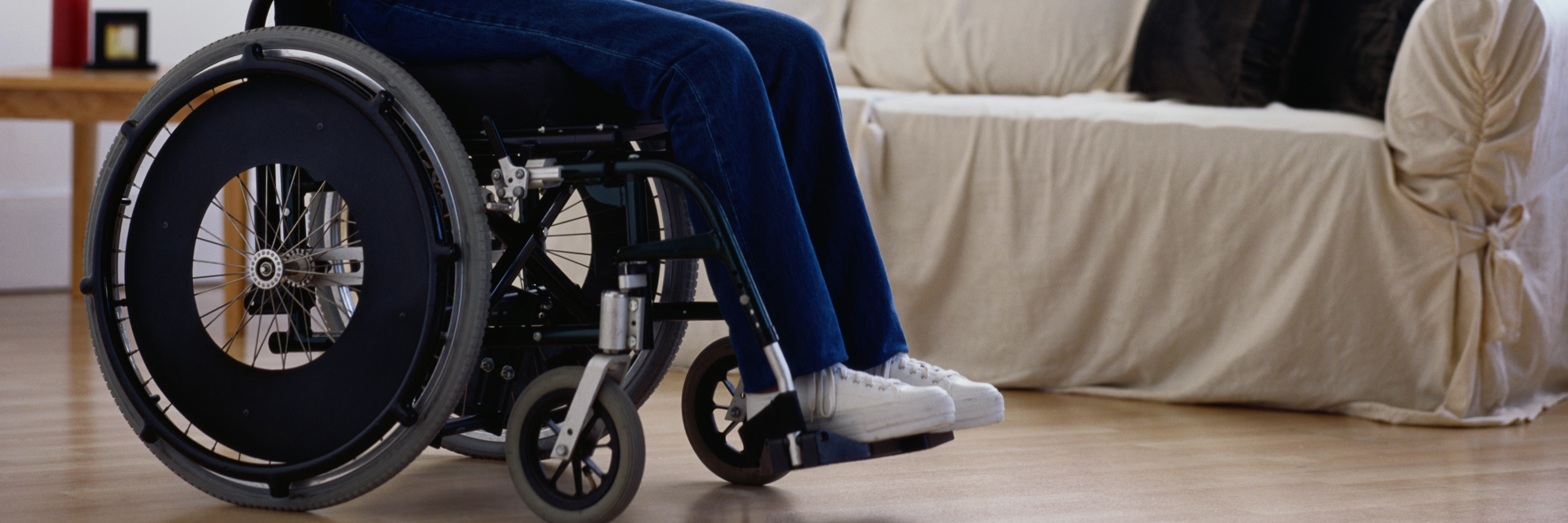 Being 'The Woman in the Wheelchair' Woman sitting in wheelchair, looking towards windows, side view.