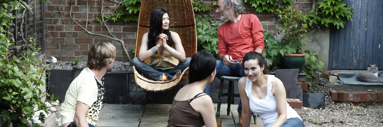 Community Support Groups Can Ease the Isolation of Mental Illness Group of friends relaxing in courtyard