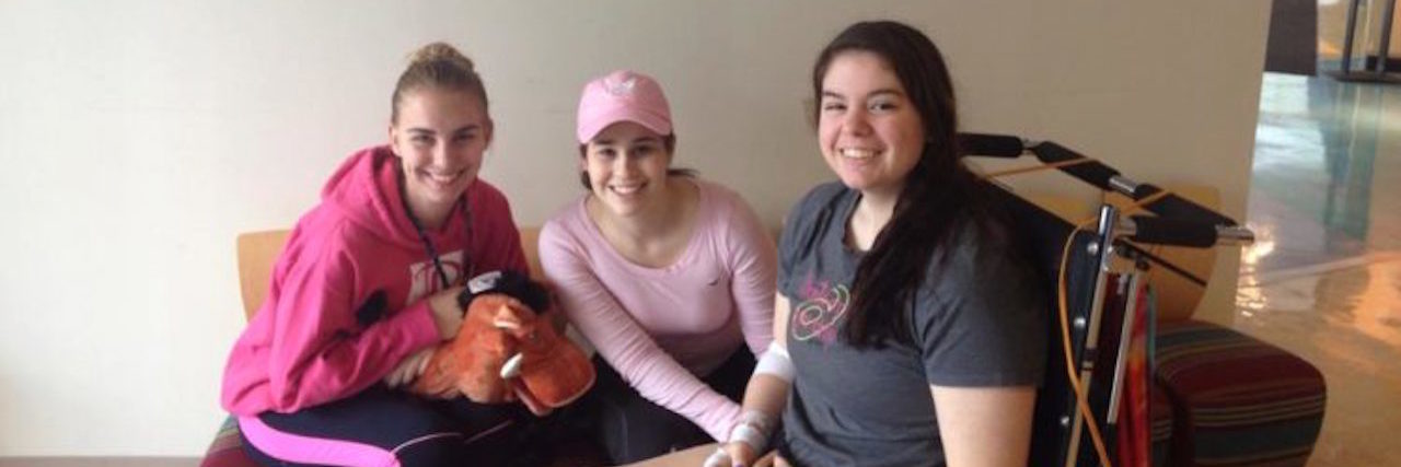 10 Things I Wish I Knew When I Was Diagnosed With CRPS The writer in a wheelchair, and two of her friends.