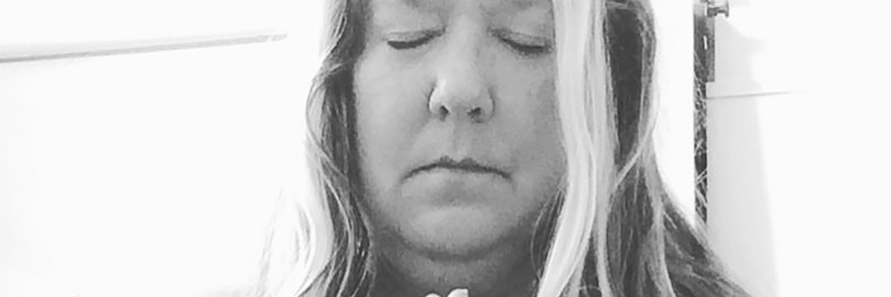 Why We Need to Talk About the Link Between Brain Injury and Depression black and white photo of woman with hands placed together