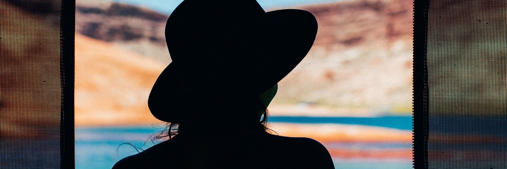 Thoracic Outlet Syndrome: Hiding My Chronic Pain, Feeling Invisible silhouette of a woman against a lake and red hills