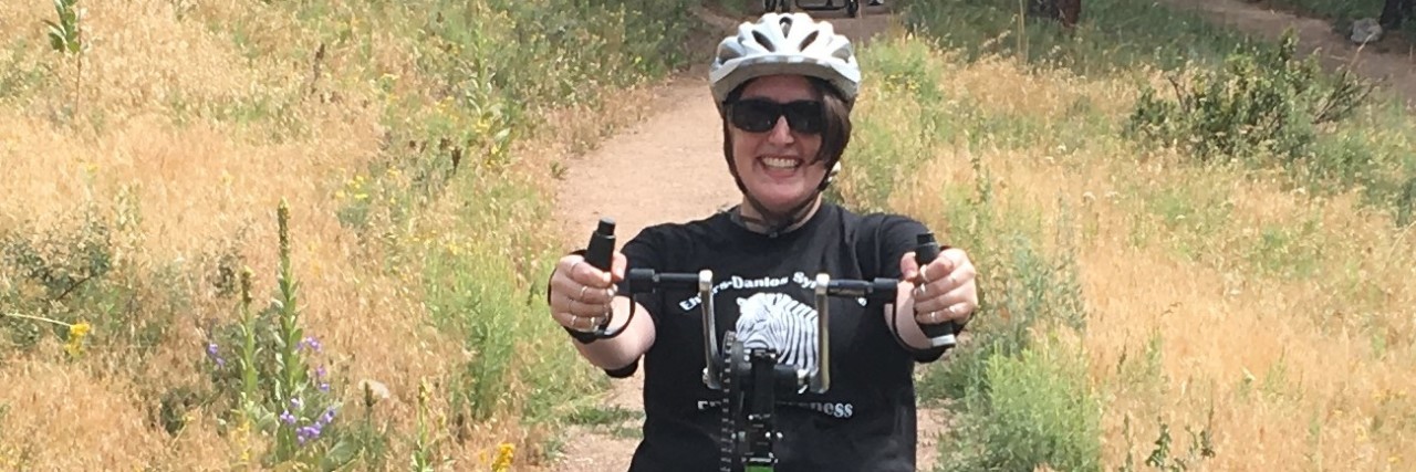 Testing an Adaptive Handbike With Ehlers-Danlos Syndrome Michelle Hardy riding an adapted recumbent bike.