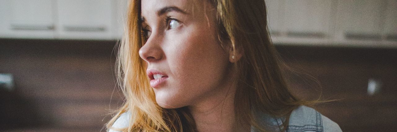 What You Should Know About Avoidant Food Intake Disorder A young woman stands in the kitchen with a glass of milk