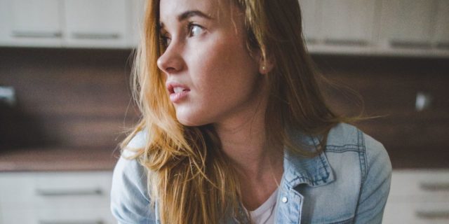 10 Things Someone With Avoidant Food Intake Disorder Wants You to Know A young woman stands in the kitchen with a glass of milk