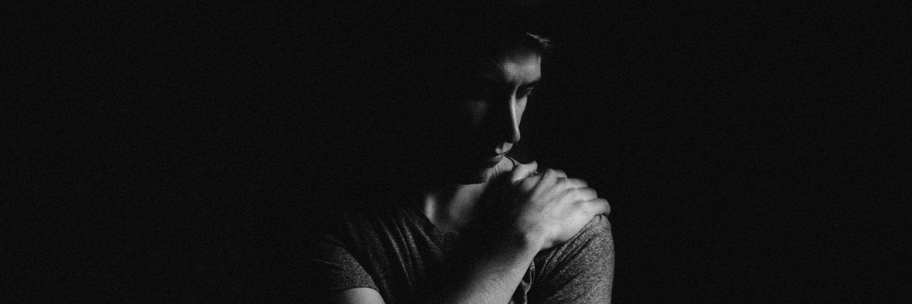 Anxiety: How Catastrophization Makes Me Afraid Every Day young man in darkness looking depressed anxious