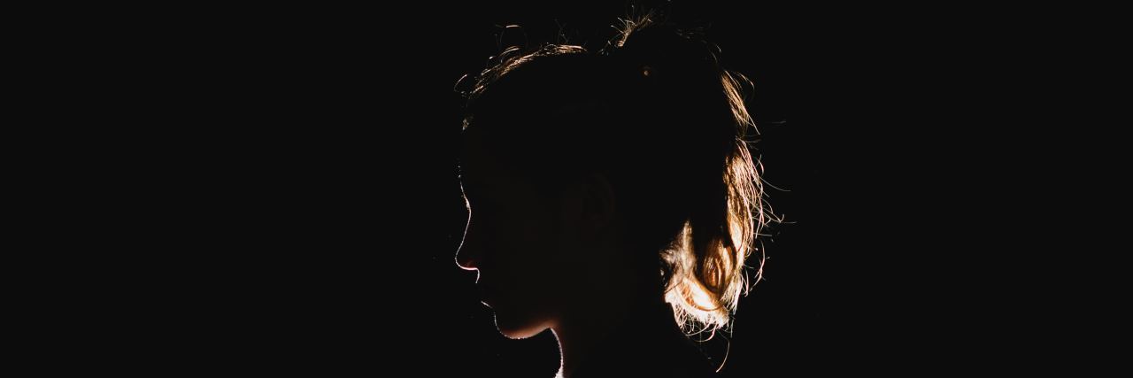 a woman's silhouette is outlined by light