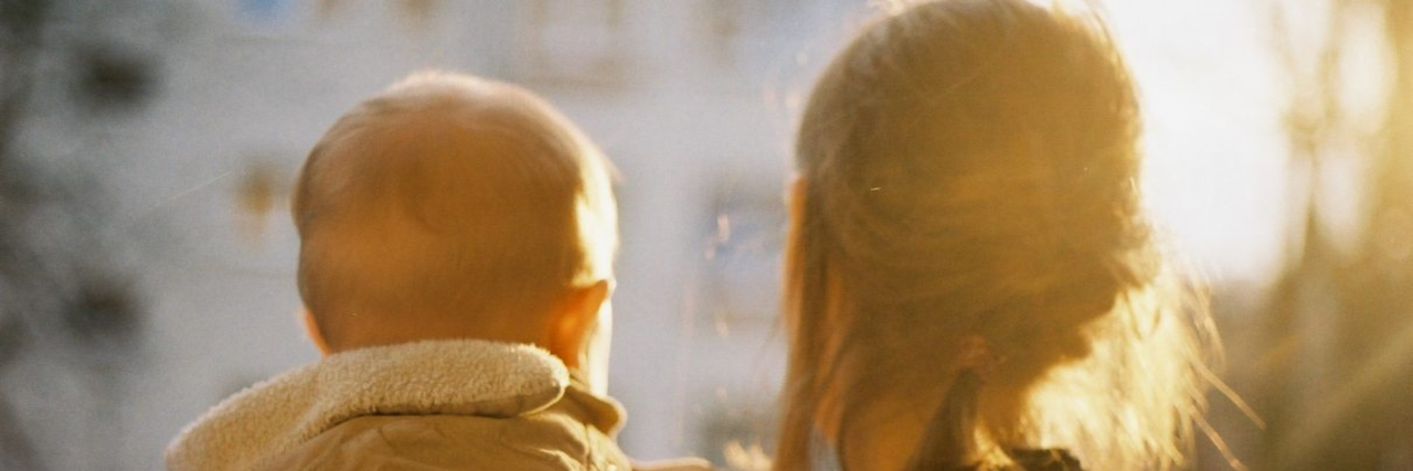 To the Moms Leaving Their Children to Seek Mental Health Treatment mom holding son in the city