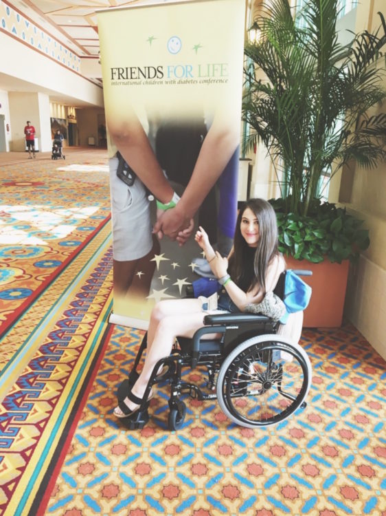 woman sitting in her wheelchair at a conference