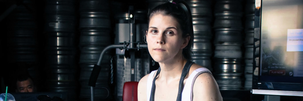 The Photo Series That Made My Invisible Illnesses Visible The writer sitting in a tire shop.