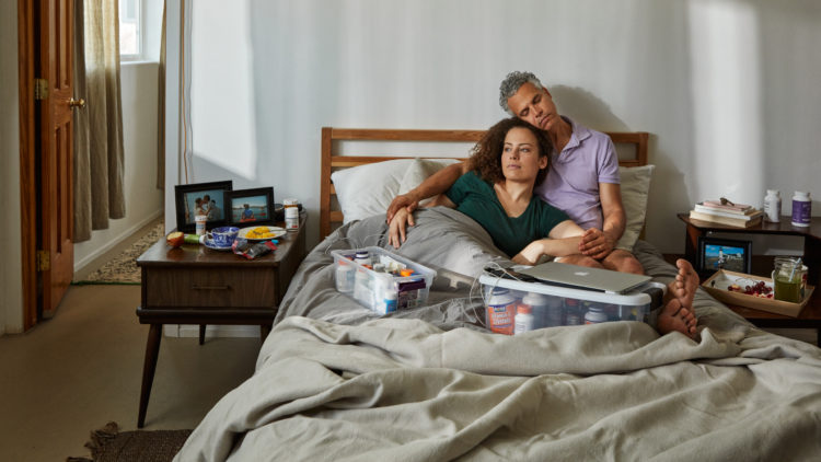 jennifer brea and omar wasow sitting in bed