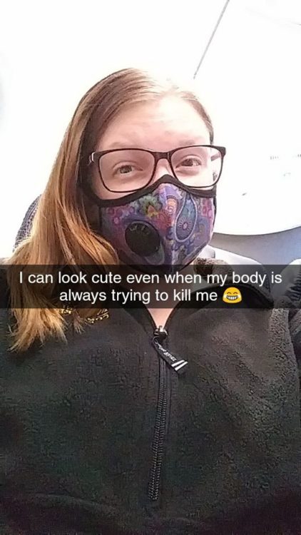 woman wearing a face mask on a plane