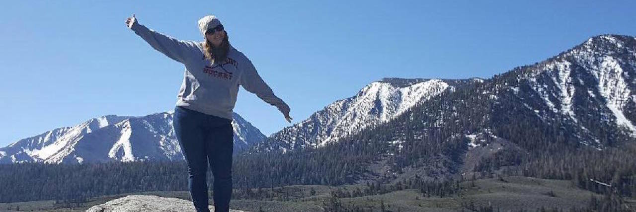 5 Things That Happened When I Became a Regular at My Chiropractor's Office The writer standing in front of a snow-capped mountain.