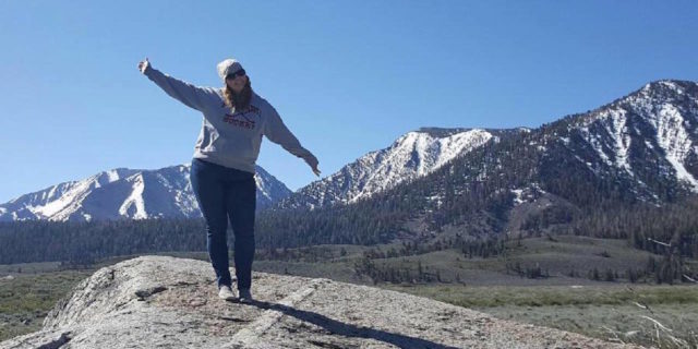 5 Things That Happened When I Became a Regular at My Chiropractor's Office The writer standing in front of a snow-capped mountain.