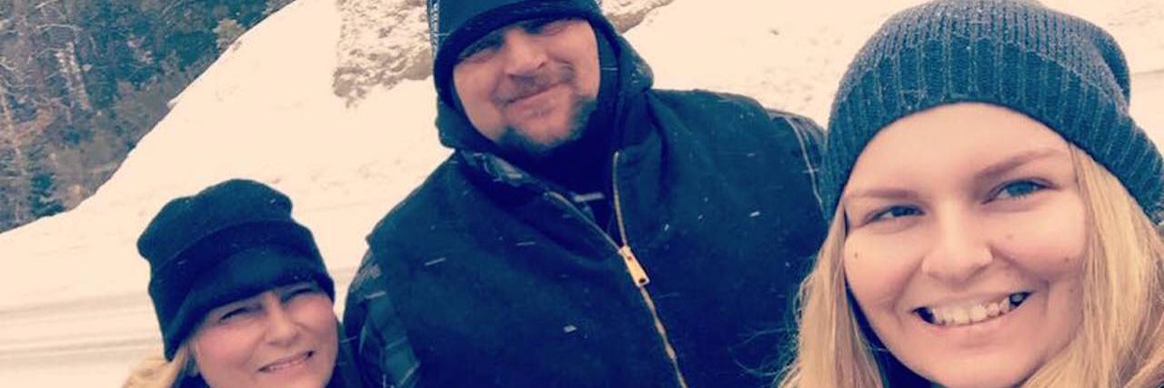 Thank You to Parents for Battling Endometriosis With Me woman smiling with her parents outside in the snow