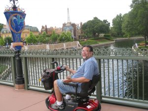 Ben using a scooter at Epcot.