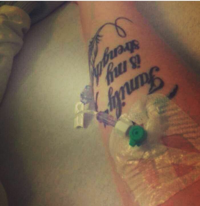 tattoo that says 'family is my strength' under an IV