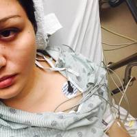 woman lying in a hospital bed wearing a hospital gown