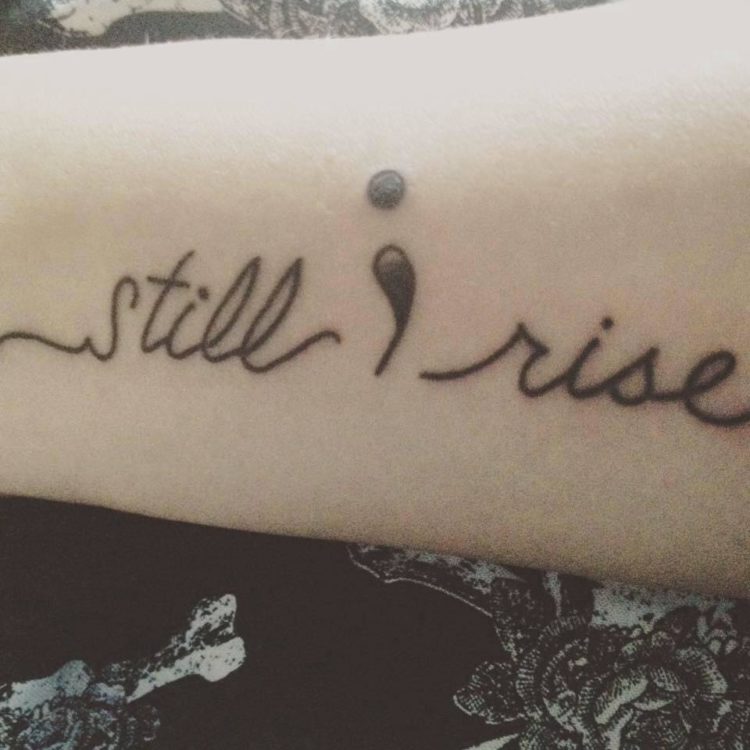 tattoo that says 'still i rise' with a semicolon