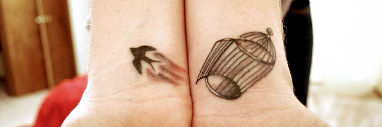 Why I Self-Harmed and How I Stopped tattoo of bird escaping from cage on girls wrist