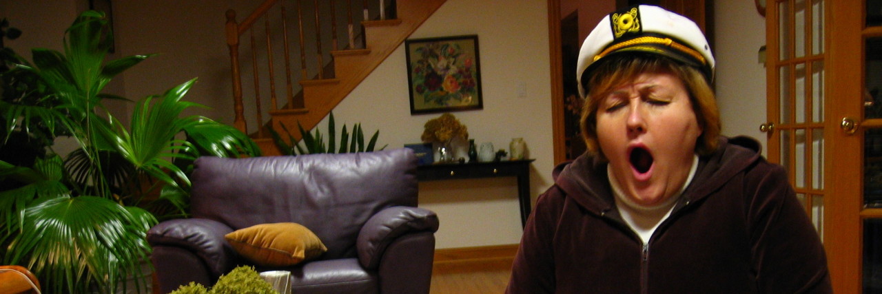 Tips for Managing Ongoing Demands as Parents of Kids With Disabilities Woman yawning