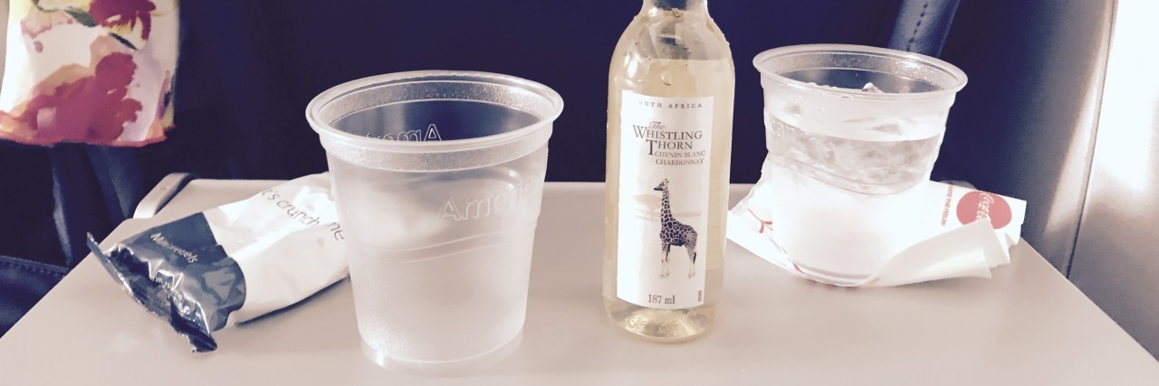 Primary Immunodeficiency: Achieving a Milestone in Graduate School celebrating with a drink on the plane