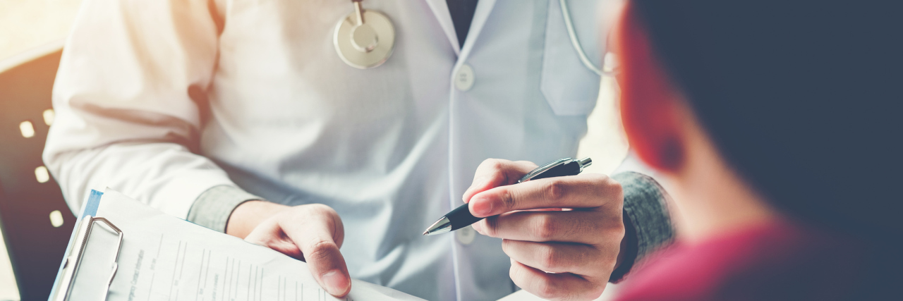 Doctors: What to Know About Undiagnosed Autoimmune Disease Patients Doctors and patients sit and talk. At the table near the window in the hospital.