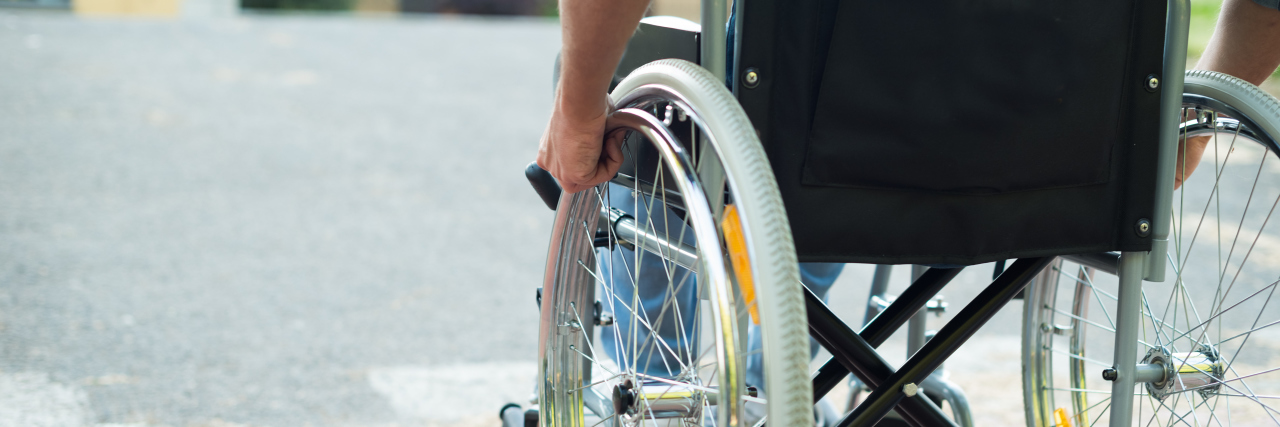 Man in a wheelchair outdoors.